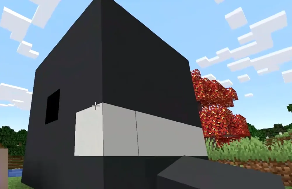 A gray concrete shark vault built in Minecraft, surrounded by trees and fences